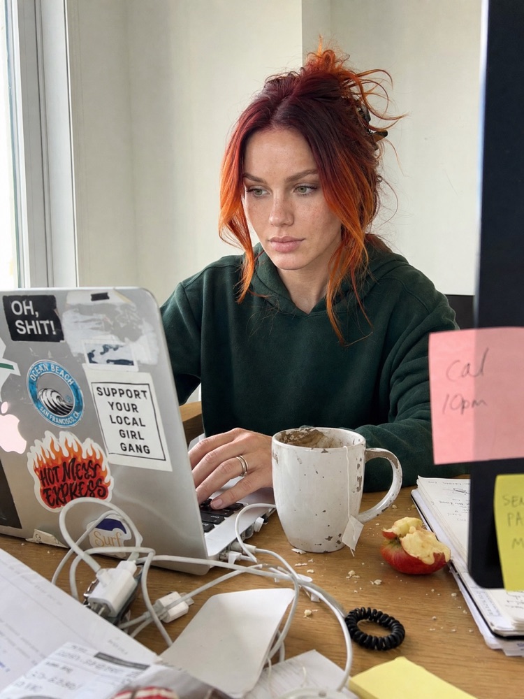 Woman working on a laptop at a desk, generated with the fixed prompt
