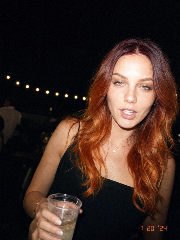 Woman at a rooftop party at night, generated with the fixed prompt