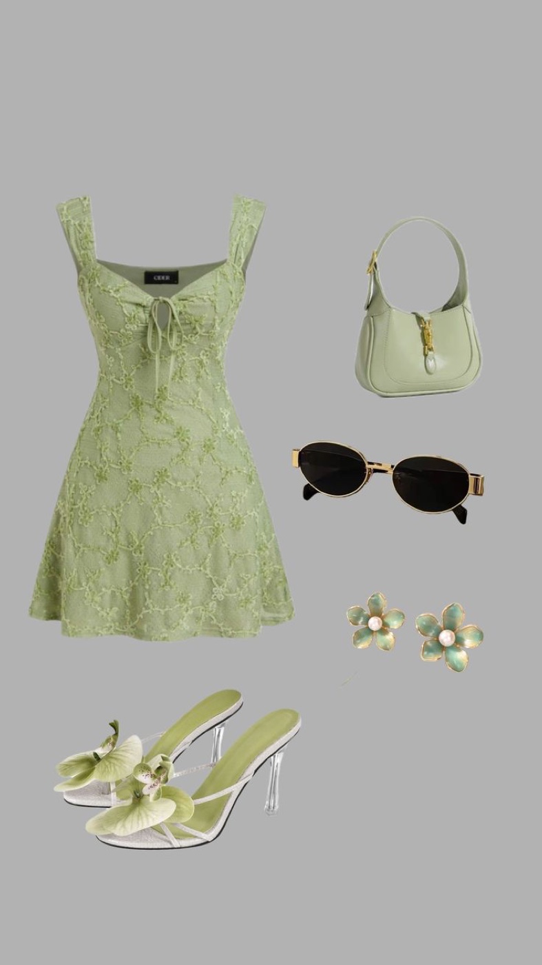 A flat lay collage of a pale green floral lace mini dress with a tie front, a mint green shoulder bag, oval sunglasses with gold frames, green and pearl flower earrings and green heeled sandals with flower details on a grey background.